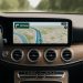 A Mercedes car dashboard with a modern infotainment screen showing navigation