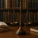 Scales of justice on a solicitor's desk with law books
