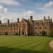 A historic English boarding school building with manicured grounds